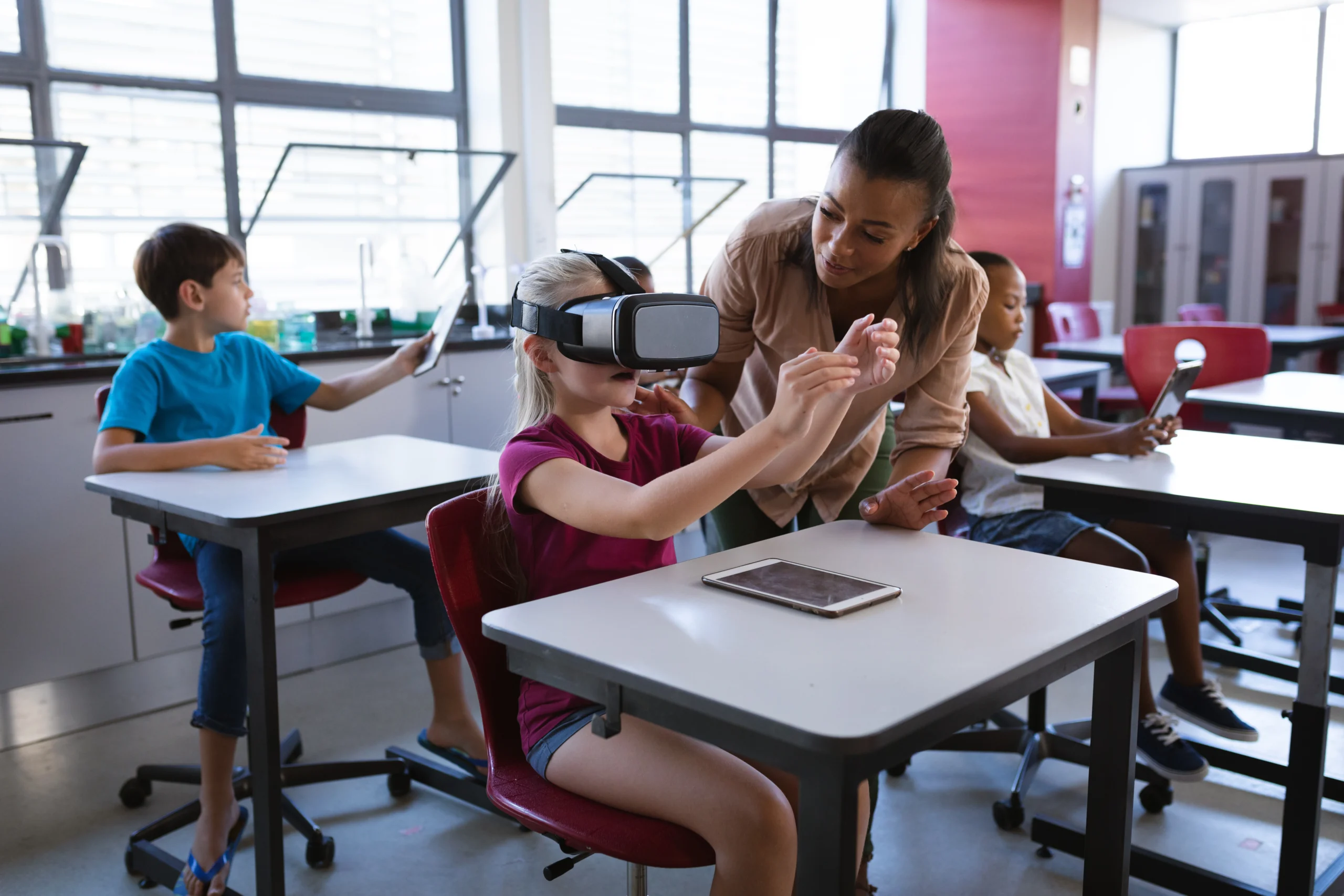 Side view portrait of little girl wearing VR headset in class and enjoying futuristic learning technology.